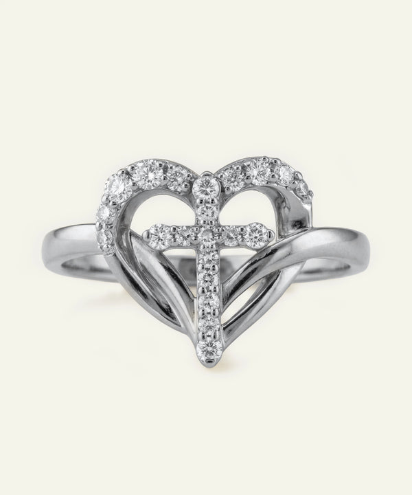 Silver heart-shaped ring with embedded diamonds on a white background