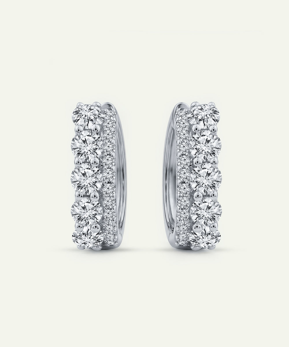 Pair of diamond hoop earrings on a light gray background