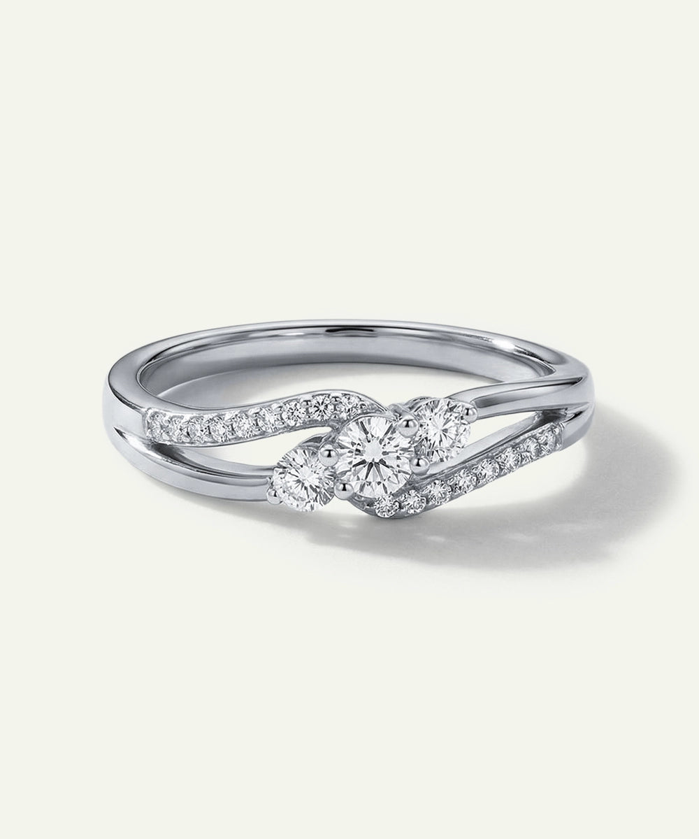 Silver ring with diamond accents on a light gray background