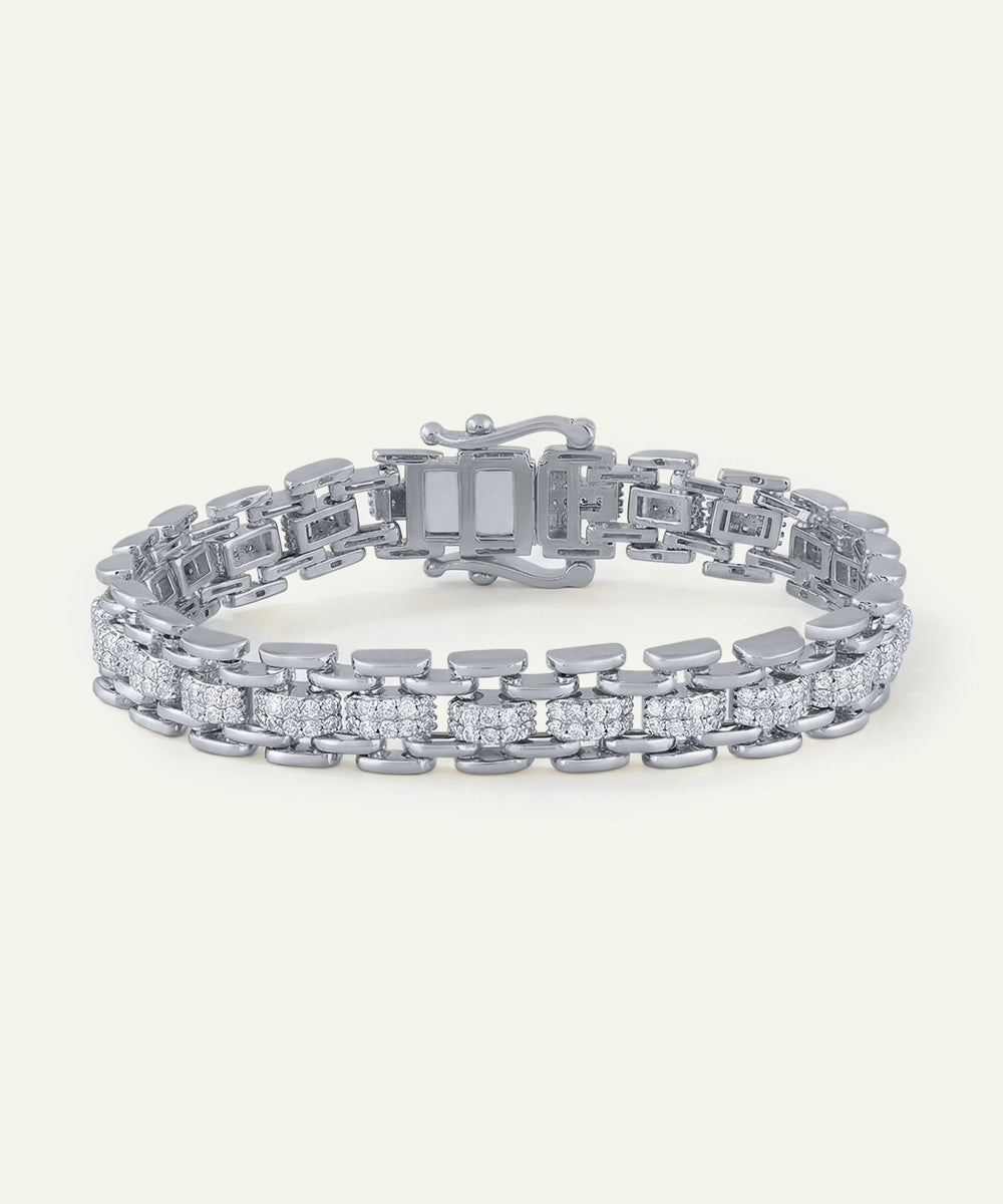 Silver bracelet with diamond accents on a white background