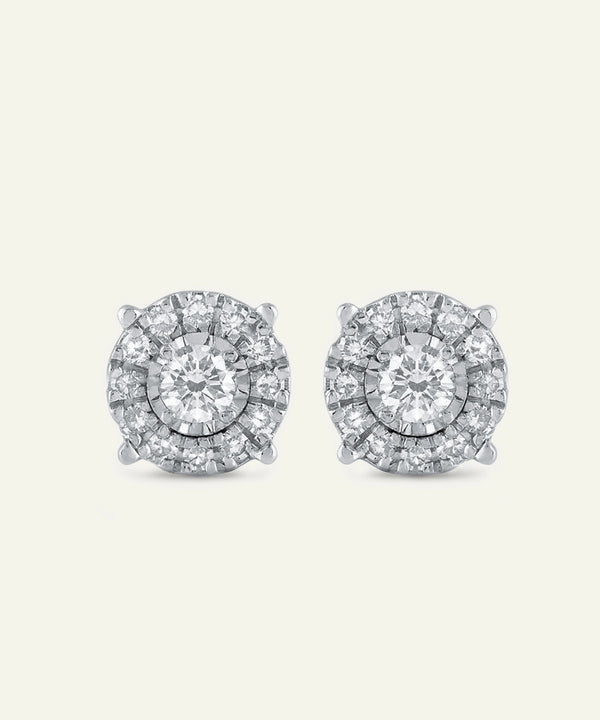 Pair of diamond stud earrings on a light gray background