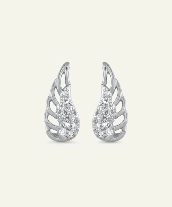Silver wing-shaped earrings with gemstones on a light gray background