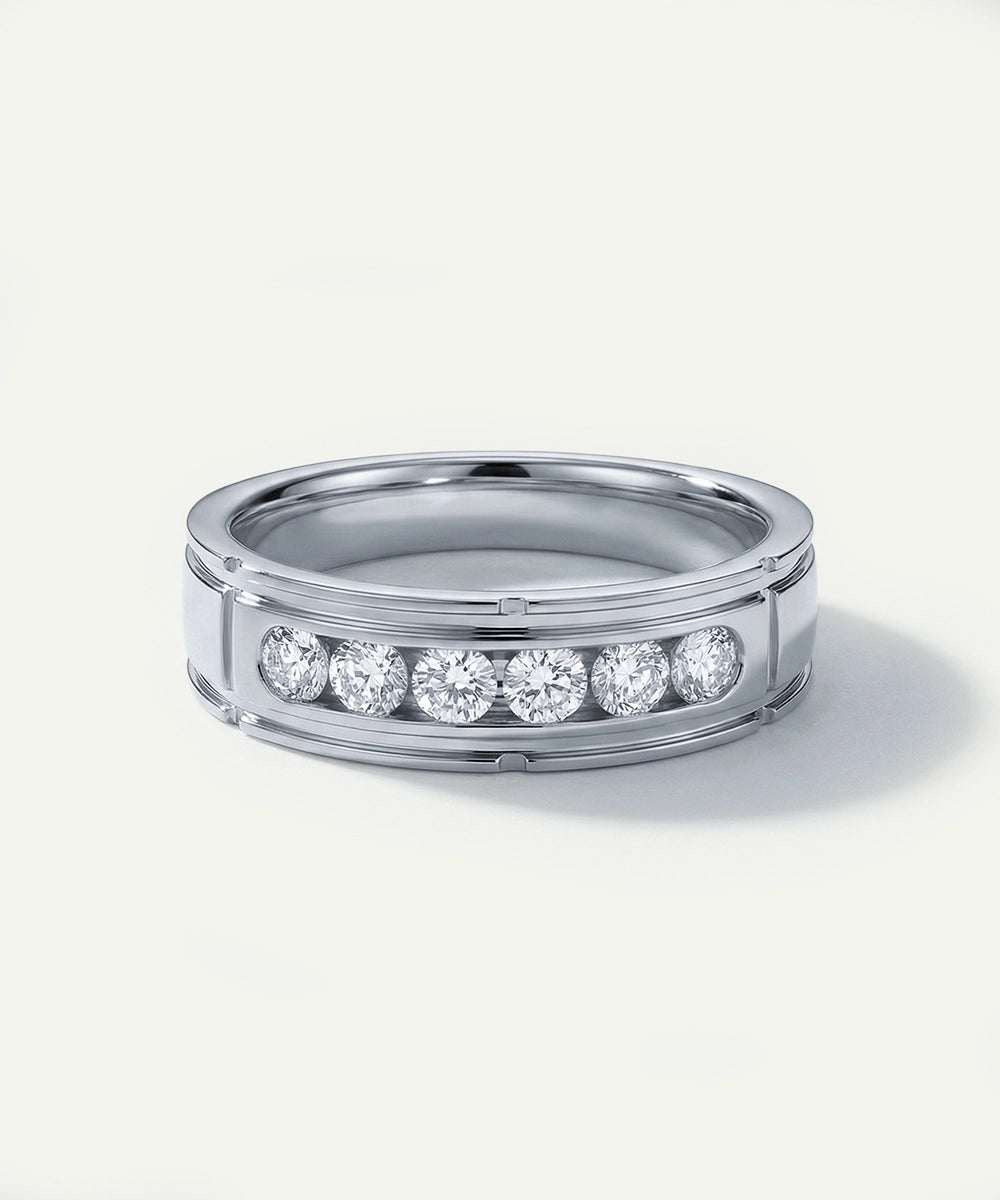 Silver ring with embedded diamonds on a white background