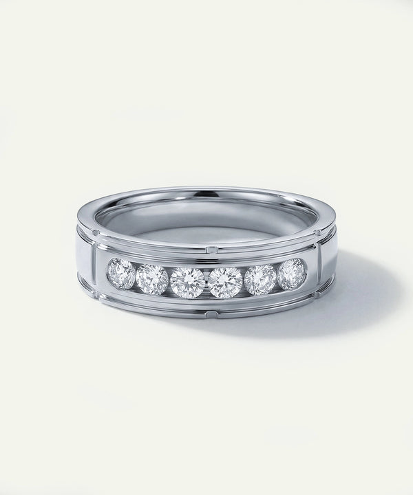 Silver ring with embedded diamonds on a white background