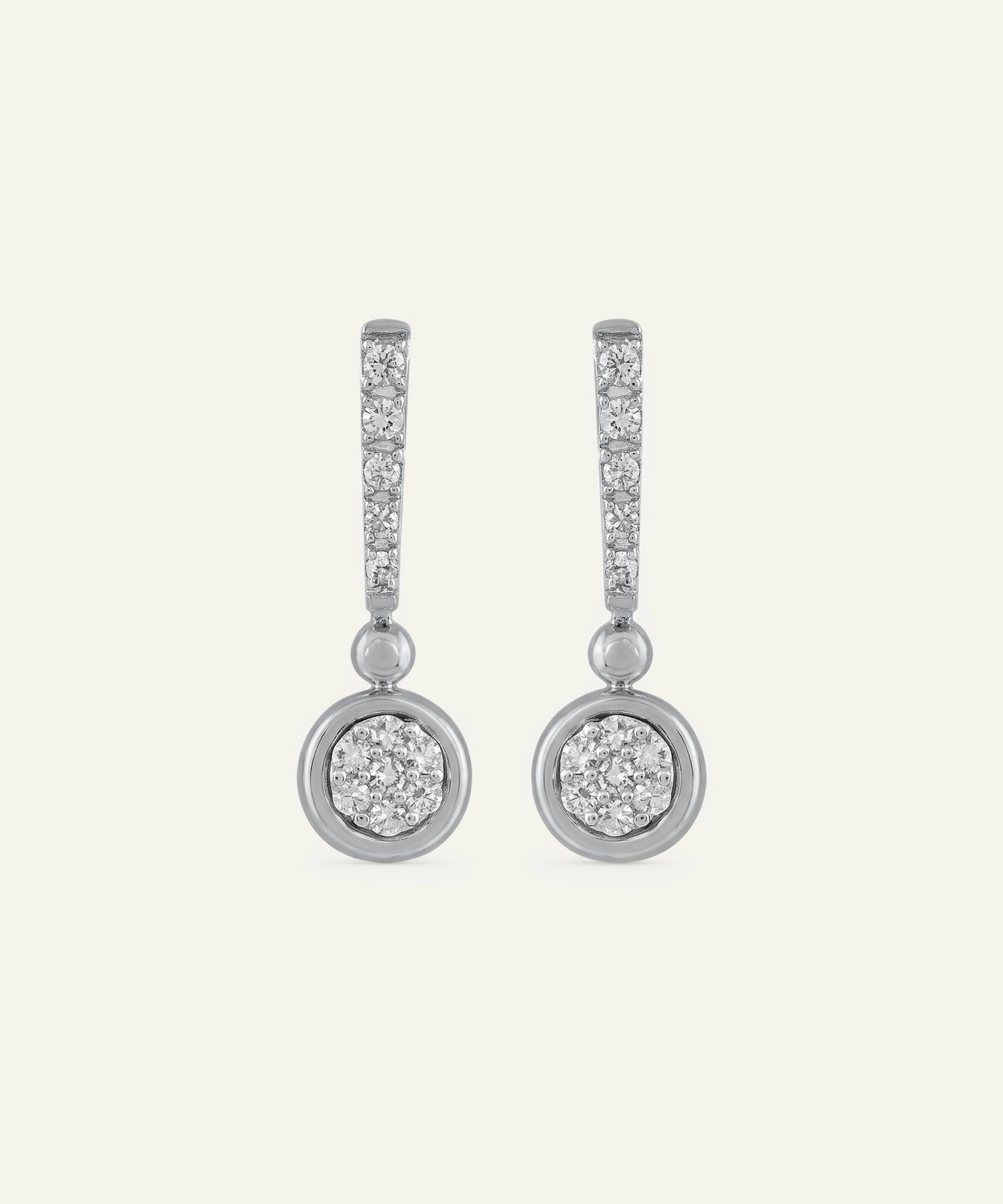 Pair of diamond earrings on a light gray background