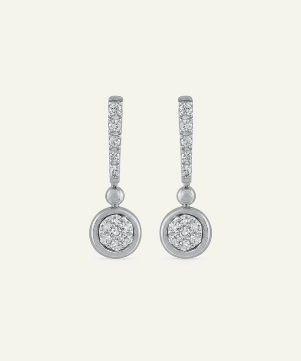 Pair of diamond earrings on a light gray background