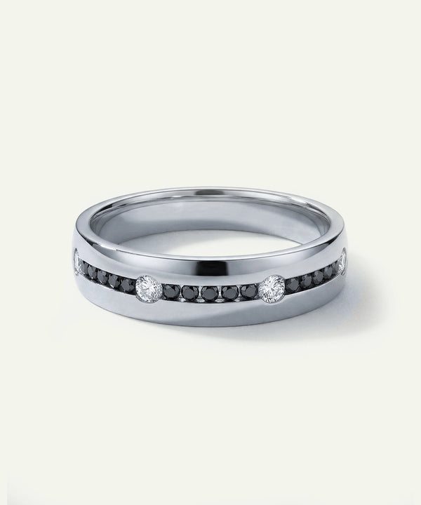 Silver ring with embedded diamonds on a white background