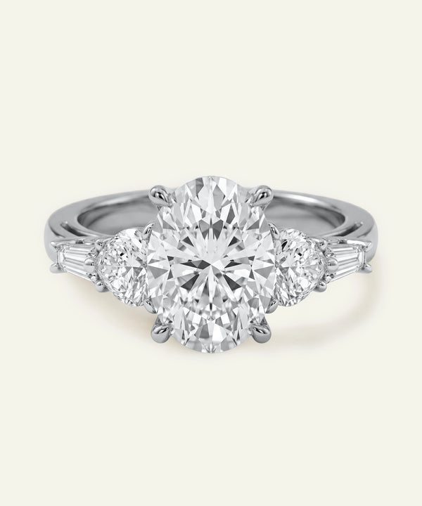 Diamond ring with a central gemstone and smaller stones on a white background