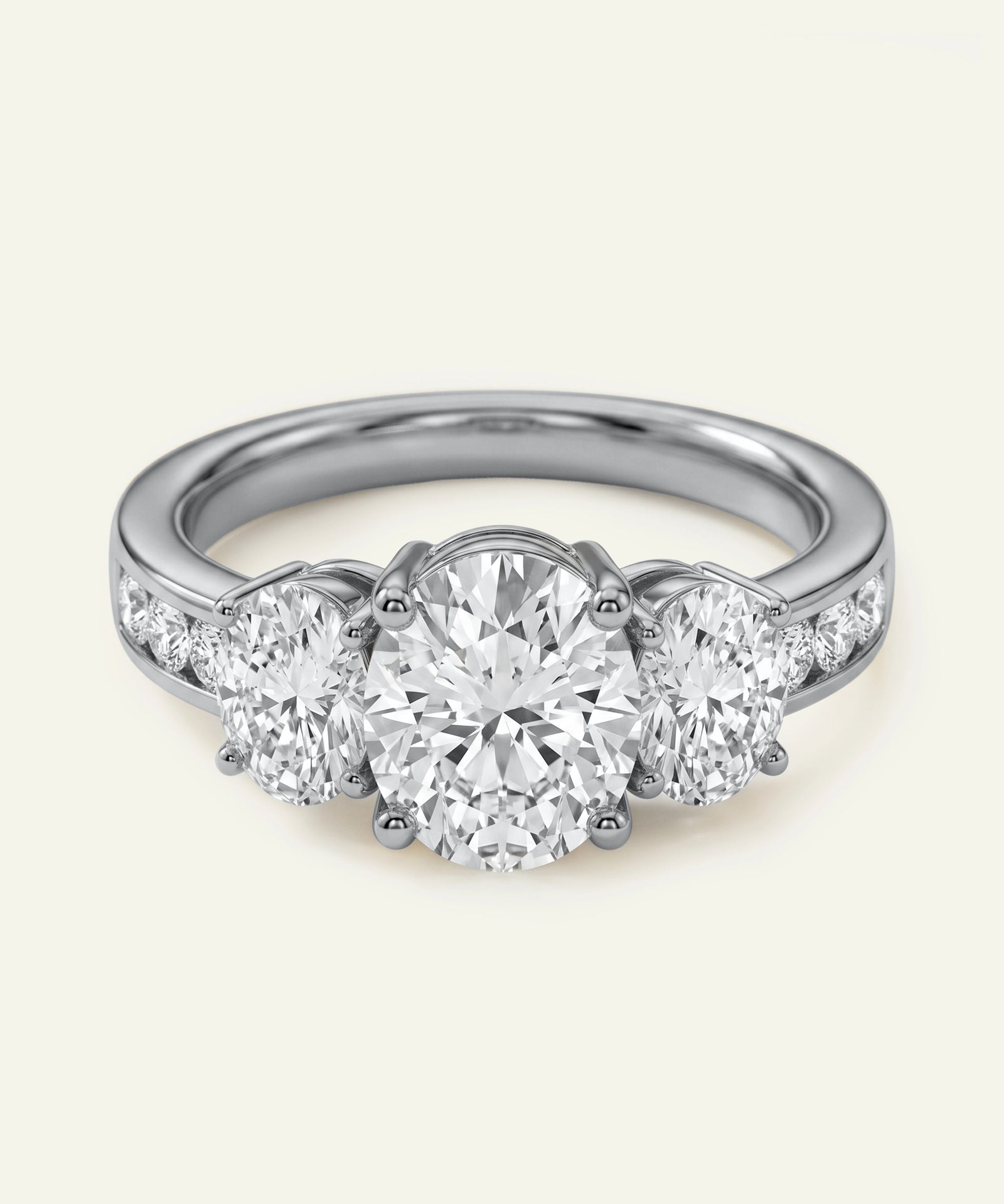 Diamond ring with three circular diamonds on a light gray background
