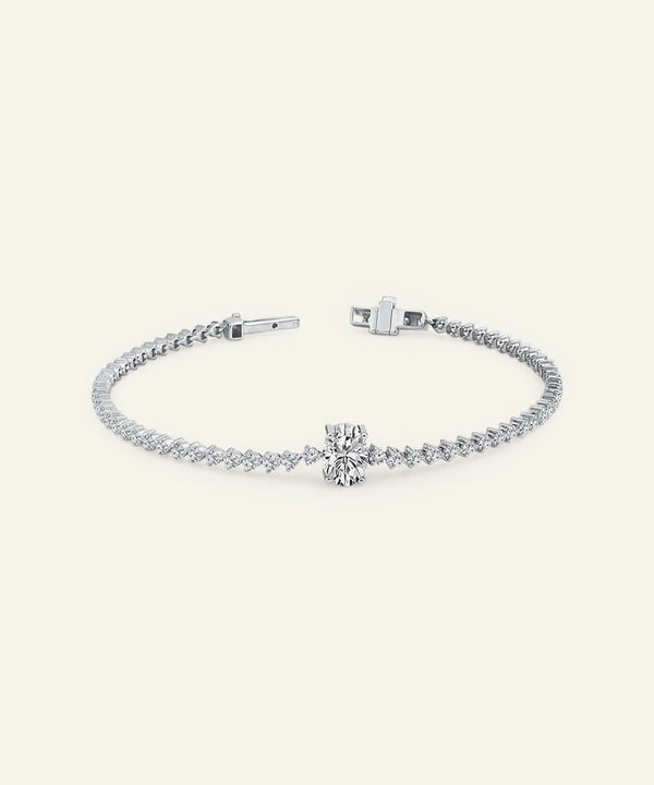 Silver bracelet with a bow charm on a white background
