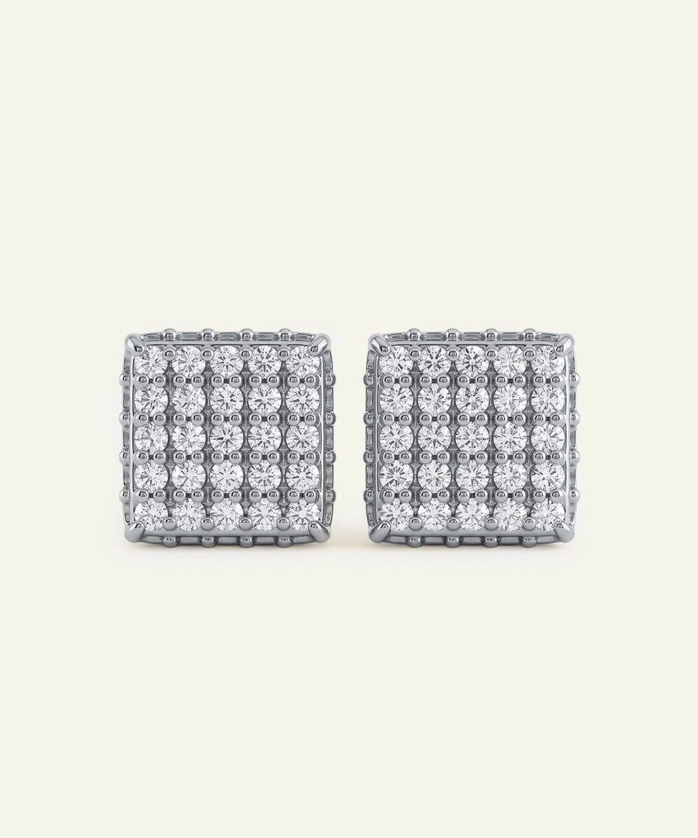 Pair of square-shaped earrings with clear gemstones on a light gray background