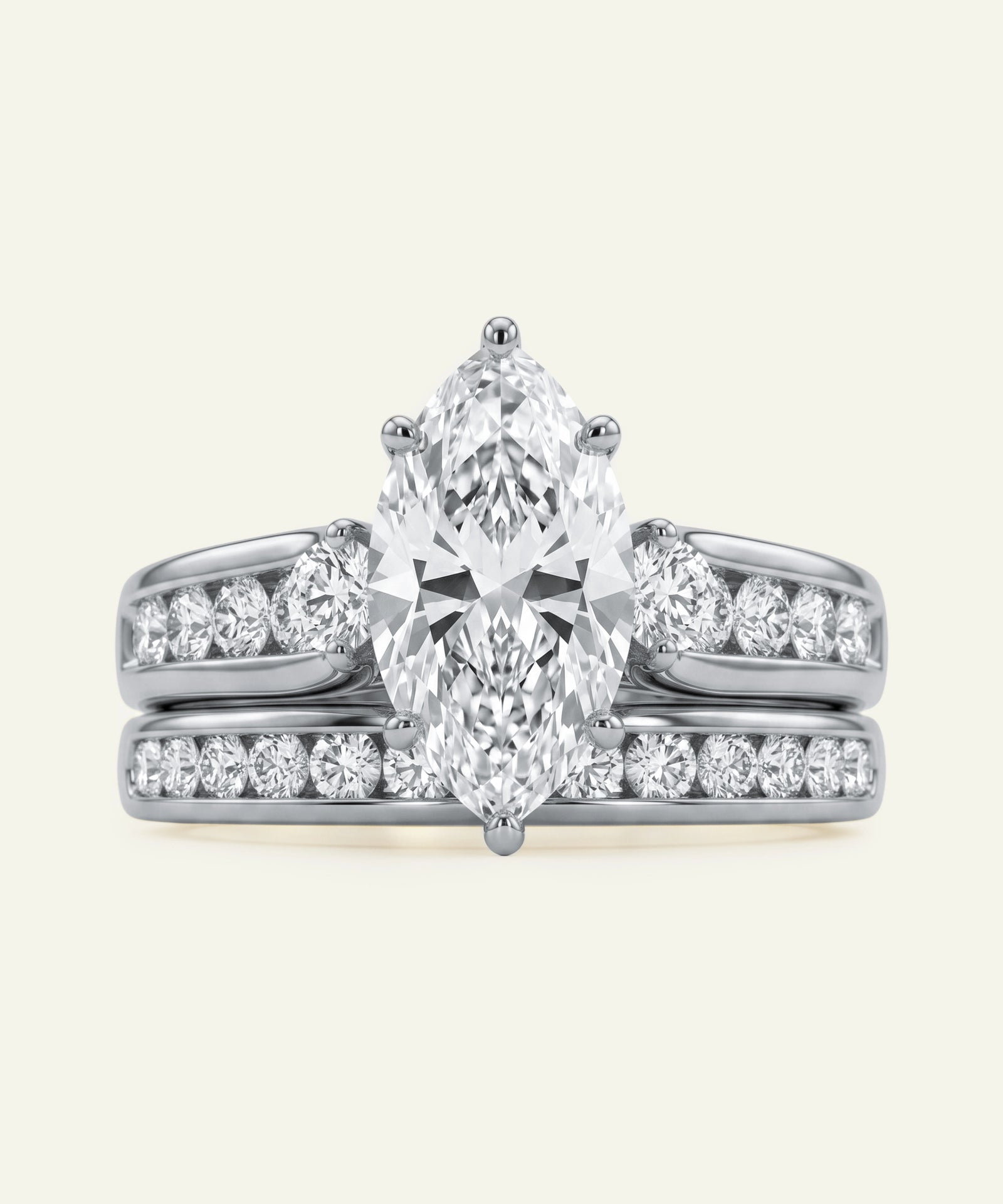 Diamond ring with a pear-shaped center stone on a white background