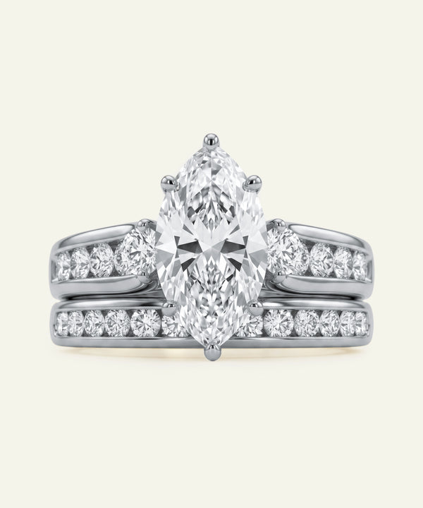 Diamond ring with a pear-shaped center stone on a white background