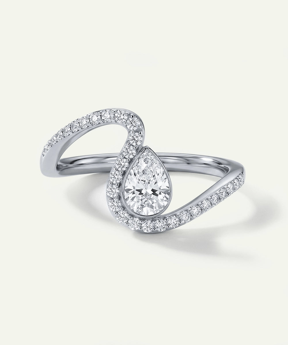 Silver ring with a pear-shaped diamond on a light gray background