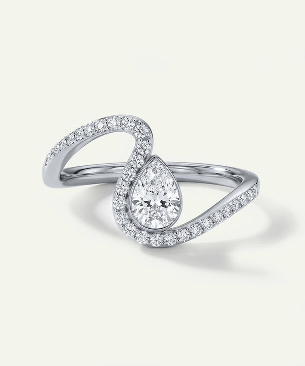 Silver ring with a pear-shaped diamond on a light gray background