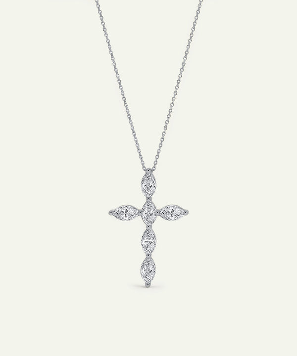 Silver cross-shaped pendant necklace on a light gray background