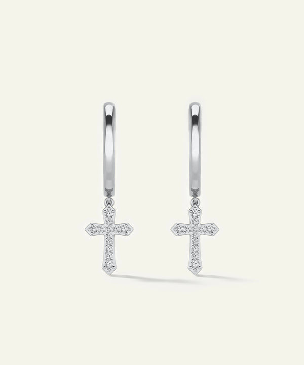 Silver cross earrings on a light gray background