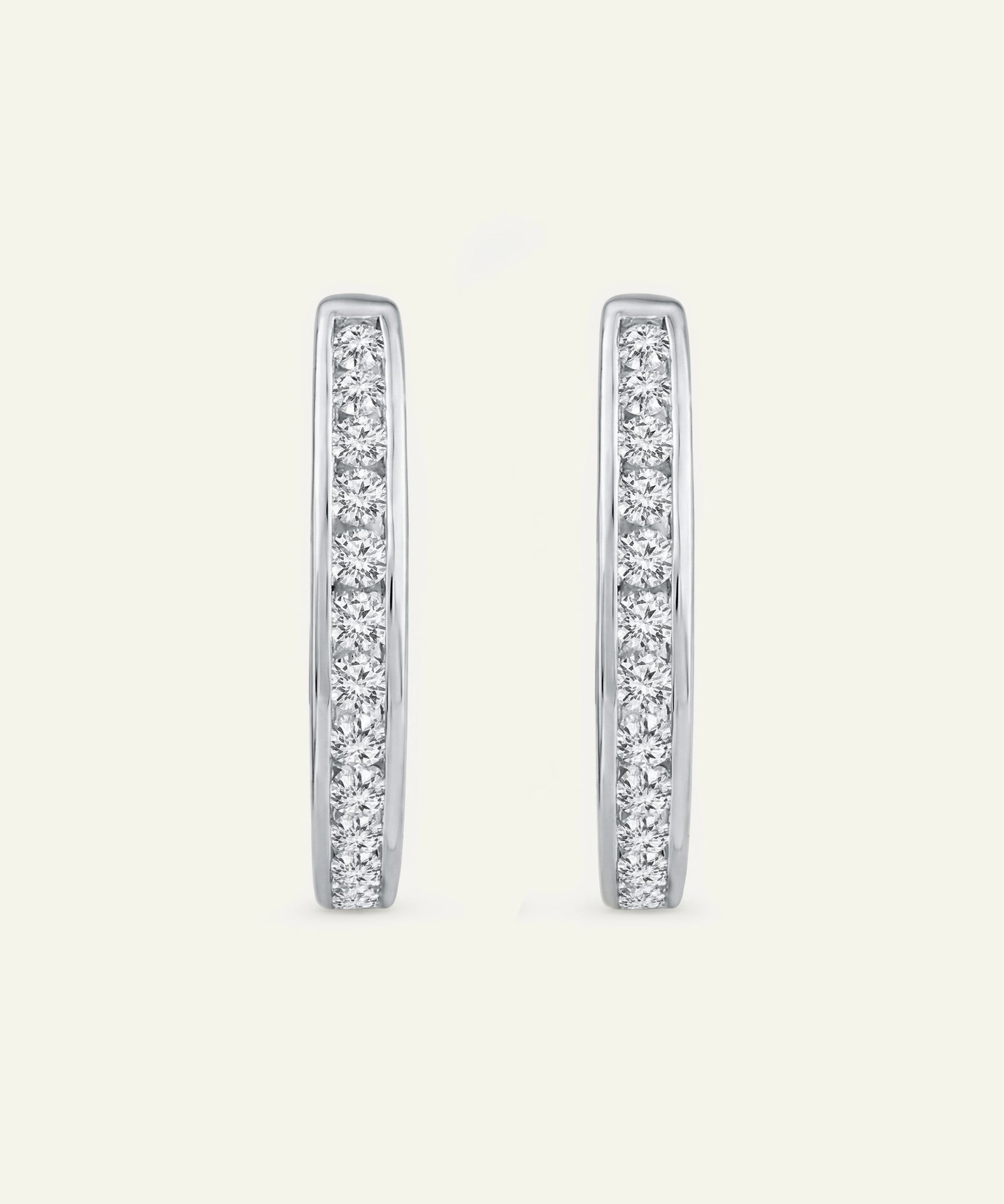 Pair of diamond hoop earrings on a light gray background