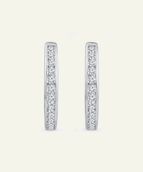 Pair of diamond hoop earrings on a light gray background