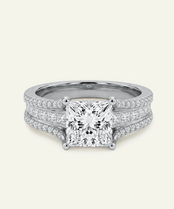 Diamond ring with a white gemstone on a light gray background