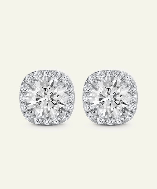 Pair of diamond stud earrings on a light gray background