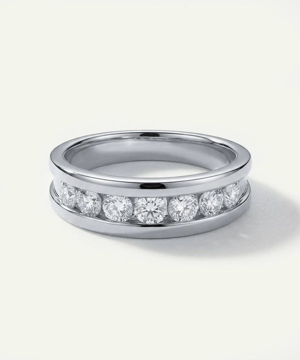 Silver ring with embedded diamonds on a white background