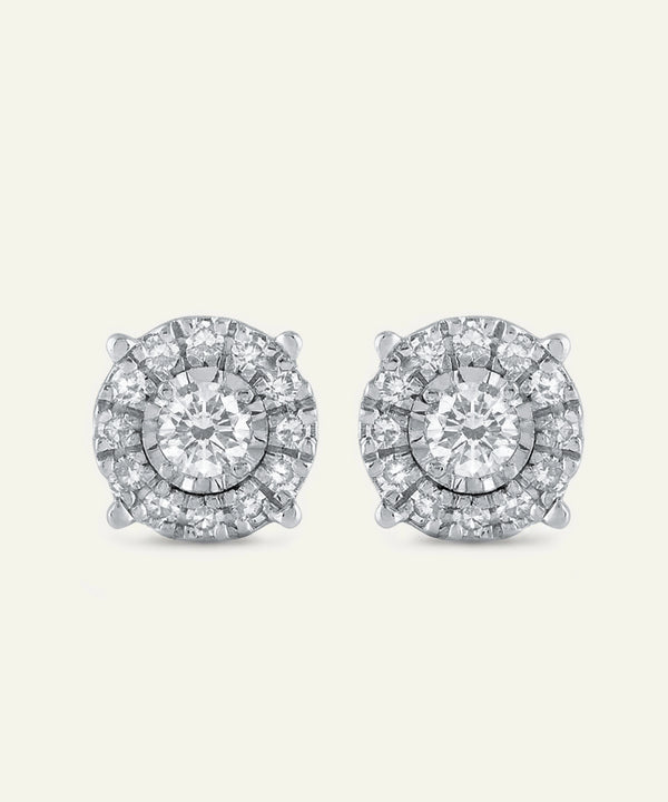 Pair of diamond stud earrings on a light gray background