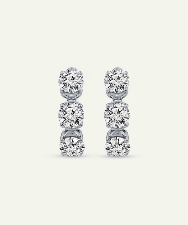 Pair of diamond stud earrings on a light gray background
