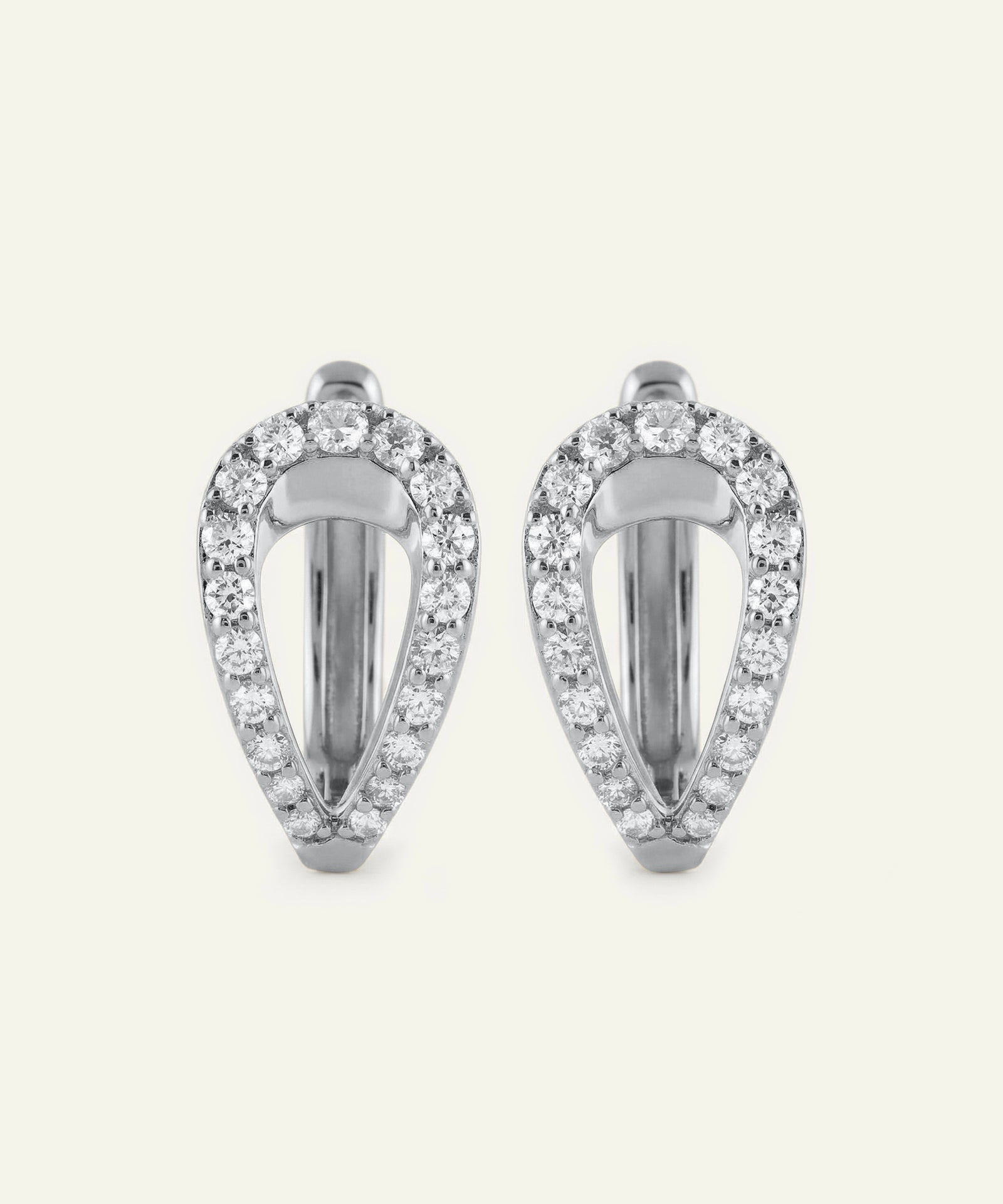 Pair of silver earrings with clear gemstones on a white background