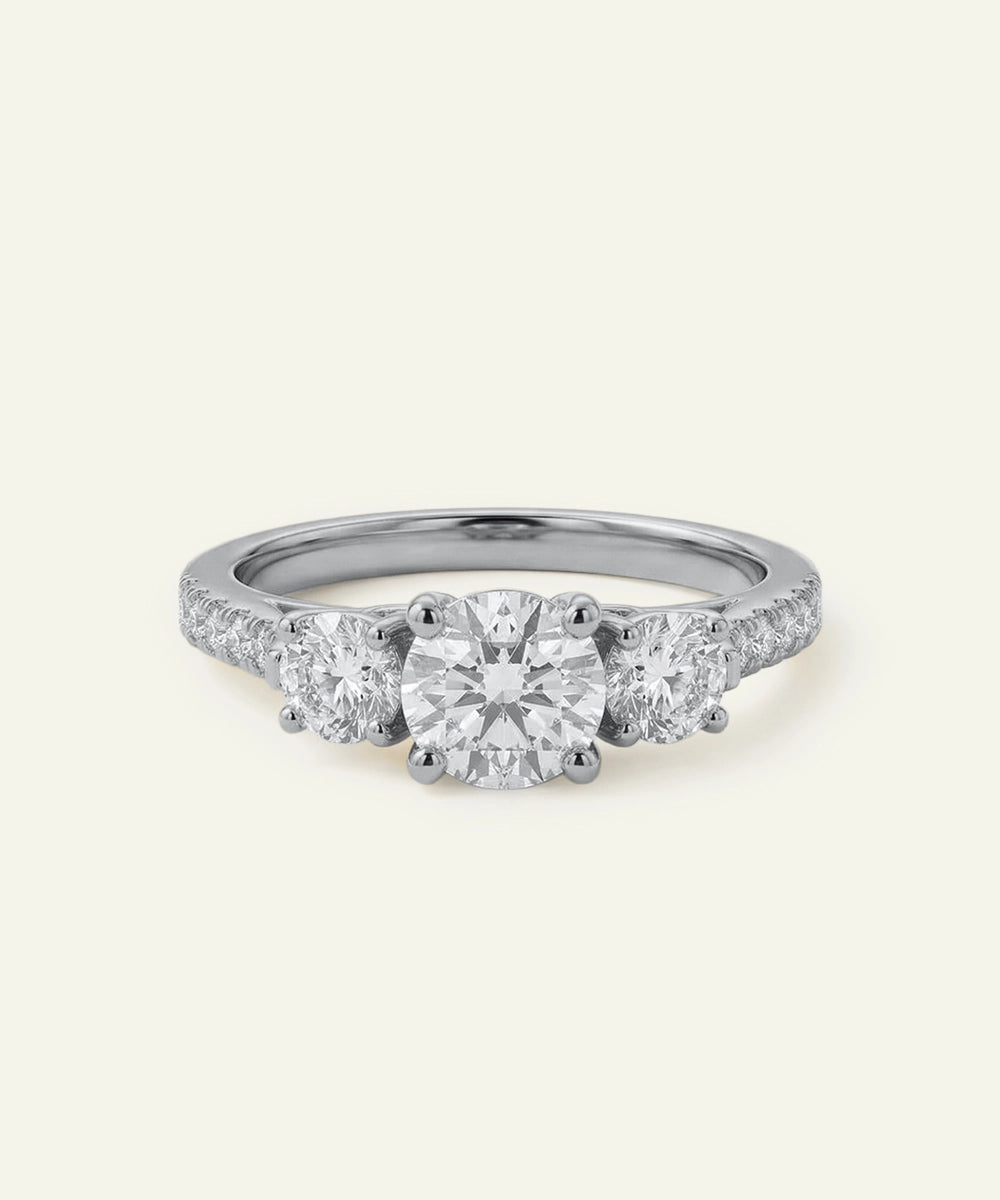 Three-stone diamond ring on a white background