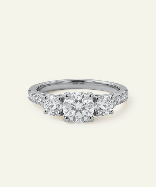 Three-stone diamond ring on a white background