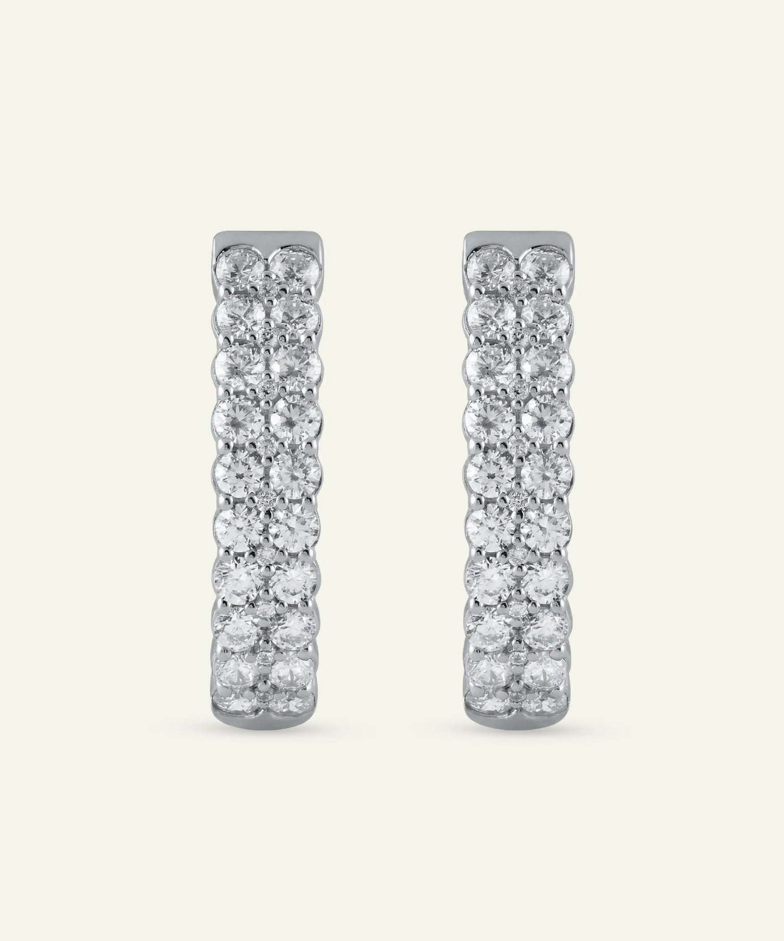 Pair of diamond earrings on a light gray background