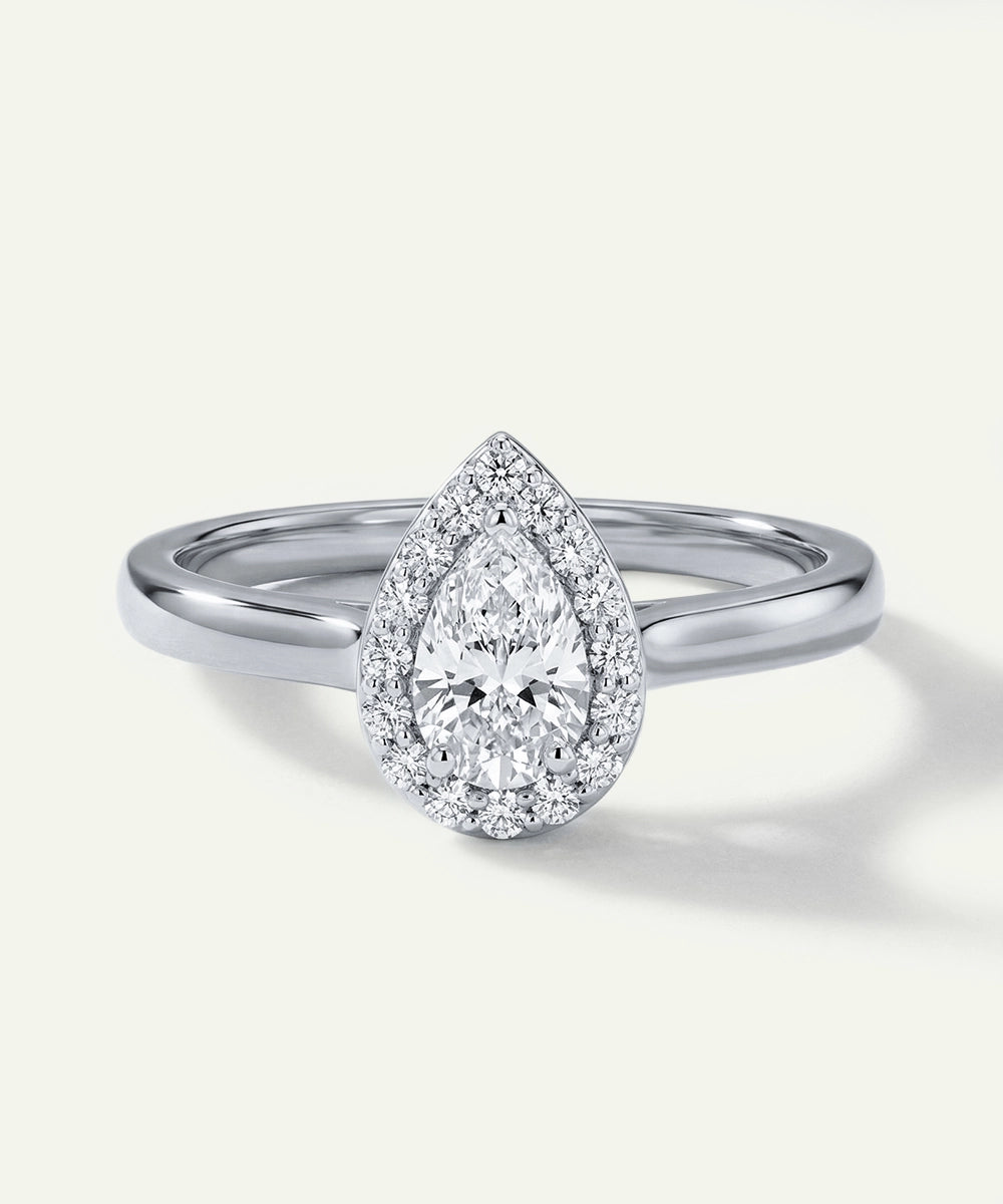 Diamond ring with pear-shaped center stone on a white background