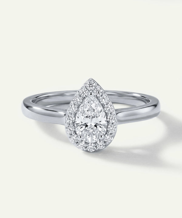 Diamond ring with pear-shaped center stone on a white background