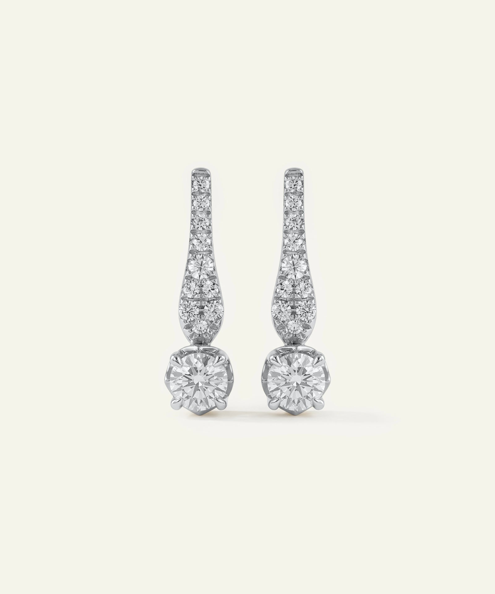 Pair of diamond earrings on a light gray background