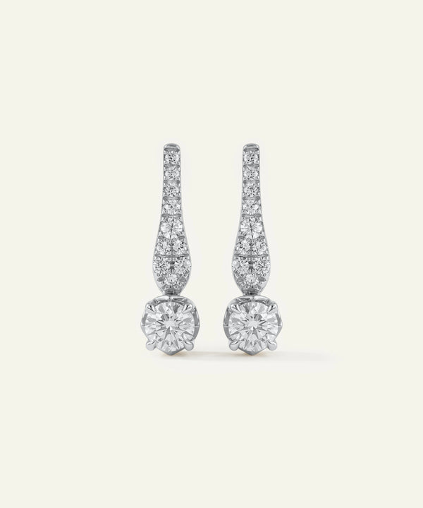 Pair of diamond earrings on a light gray background