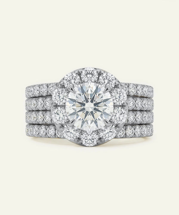 Diamond ring with a halo and multiple stones on a white background