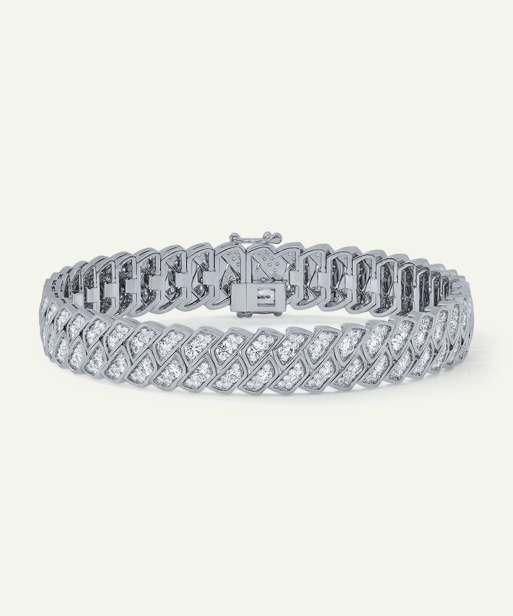 Silver bracelet with diamond accents on a white background
