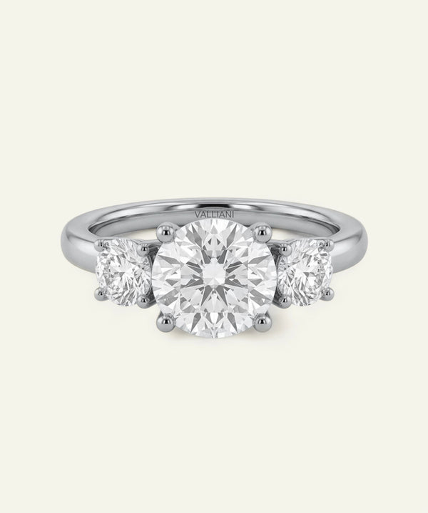 Three-stone diamond ring on a white background
