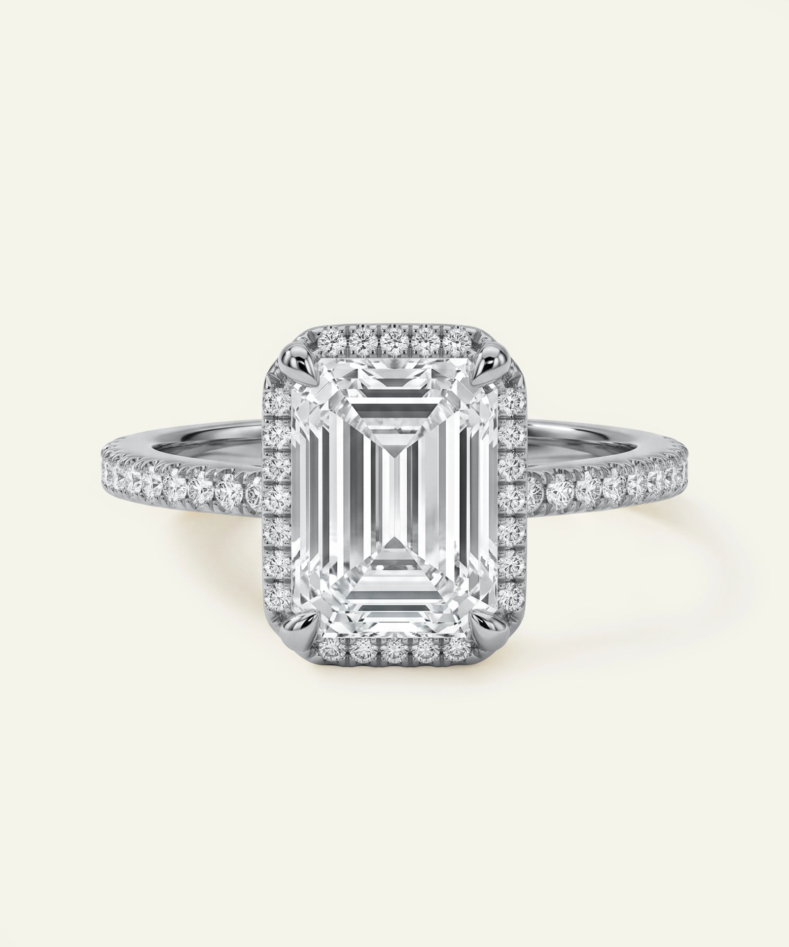 Diamond ring with a rectangular center stone on a light gray background