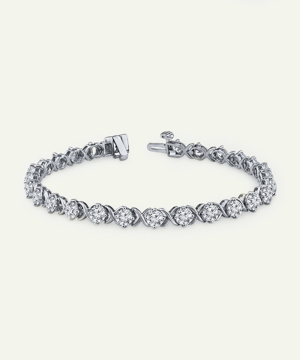 Silver bracelet with clear gemstones on a white background