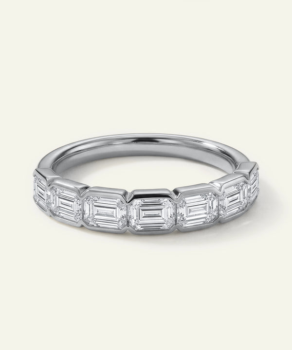 Silver ring with baguette-cut diamonds on a white background
