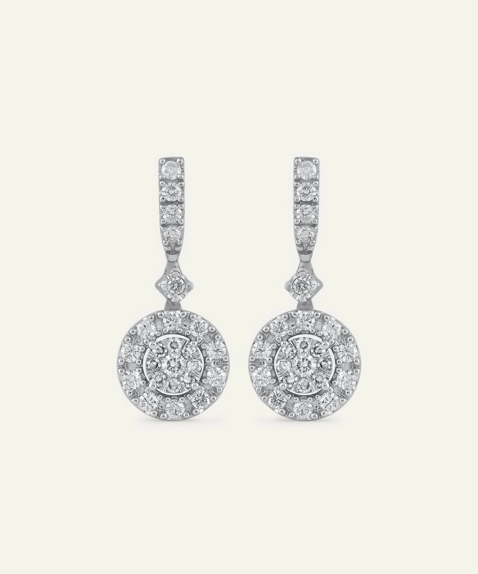 Pair of diamond earrings on a light gray background
