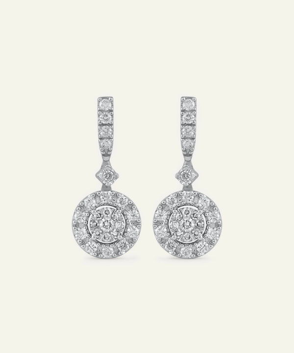 Pair of diamond earrings on a light gray background