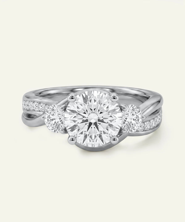 Diamond ring with three circular diamonds on a light gray background