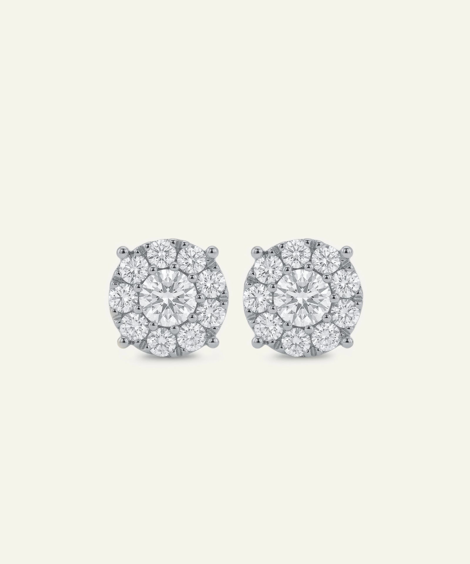 Pair of diamond stud earrings on a light gray background
