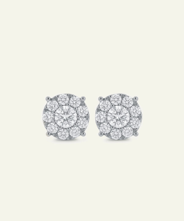 Pair of diamond stud earrings on a light gray background