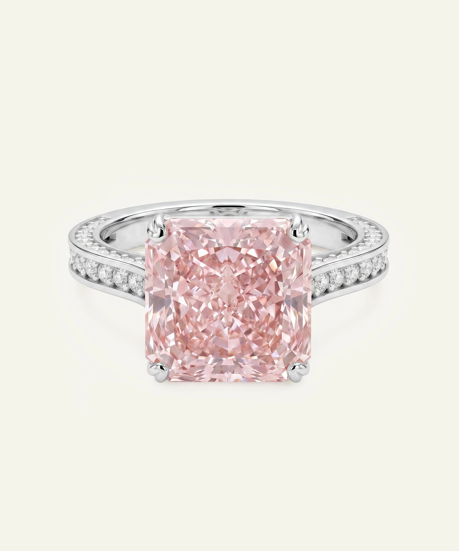 Pink diamond ring with a white gold band on a light gray background