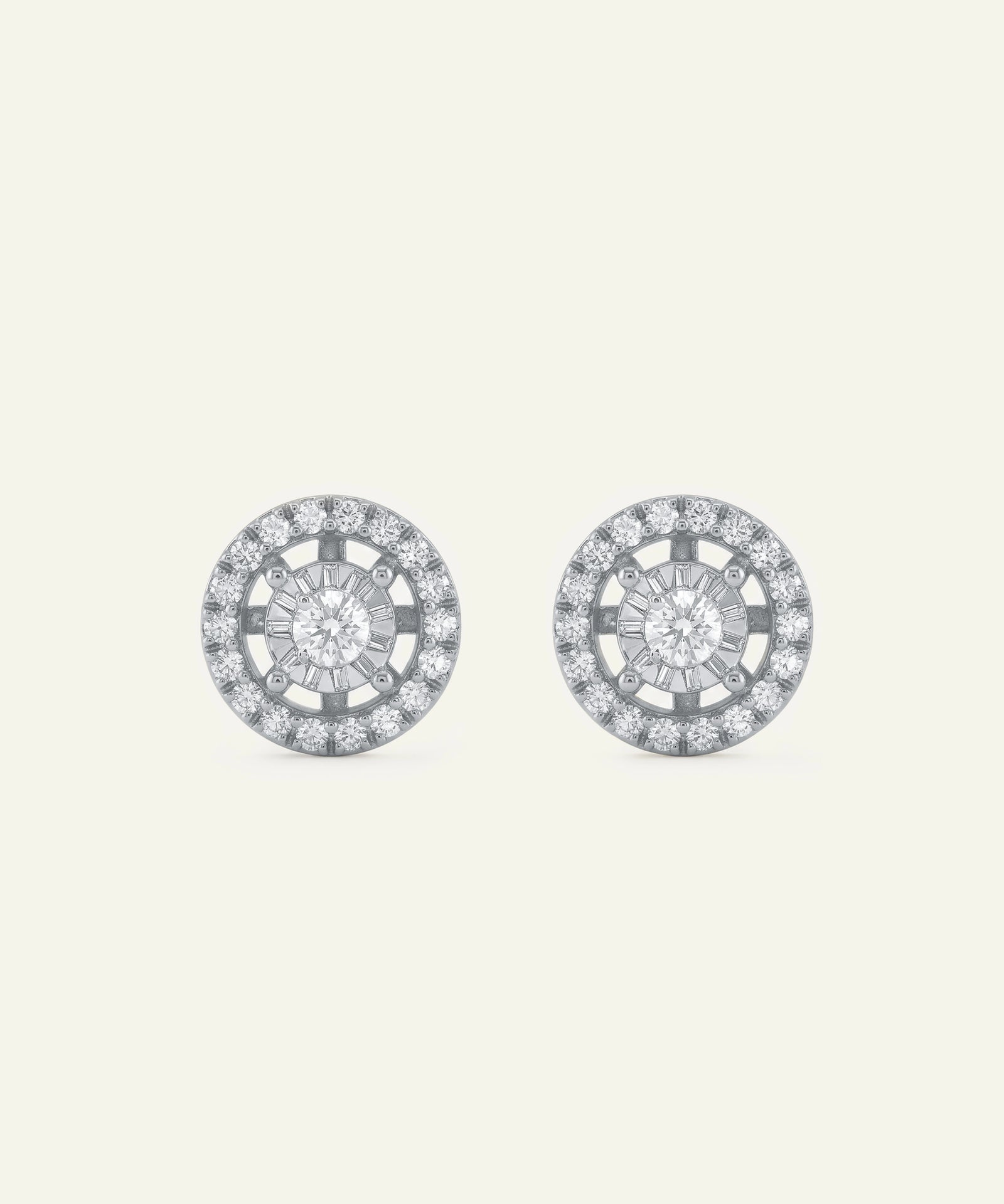 Pair of round earrings with diamond-like stones on a light gray background