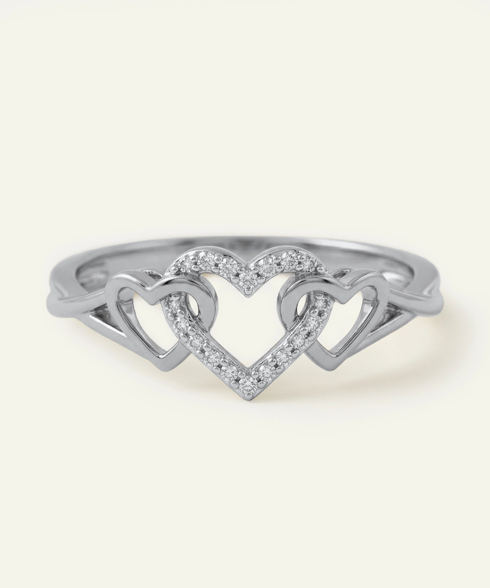 Silver ring with a heart design on a white background